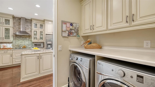 washroom with dark wood-type flooring and separate washer and dryer