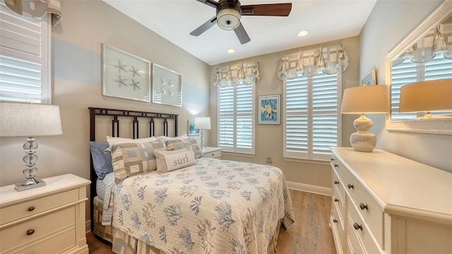 bedroom with ceiling fan and light wood-type flooring