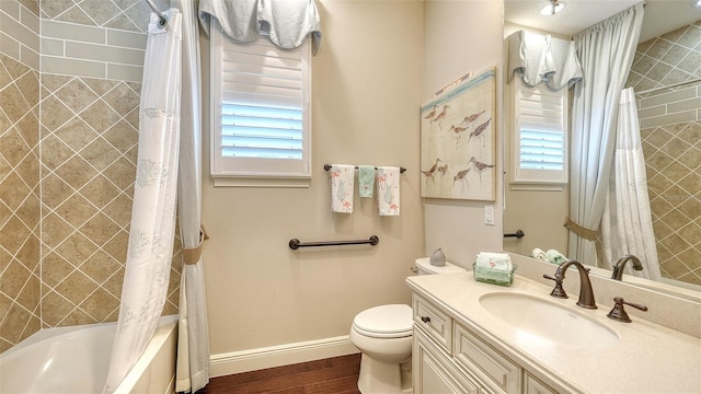 full bathroom with shower / bathtub combination with curtain, a healthy amount of sunlight, toilet, and hardwood / wood-style floors