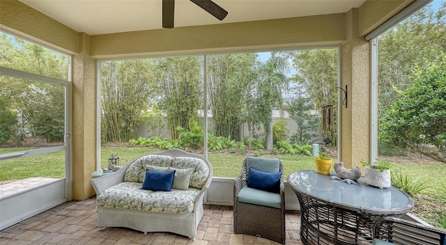 sunroom featuring ceiling fan