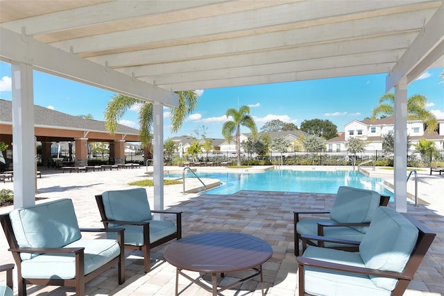 view of swimming pool featuring a pergola and a patio area