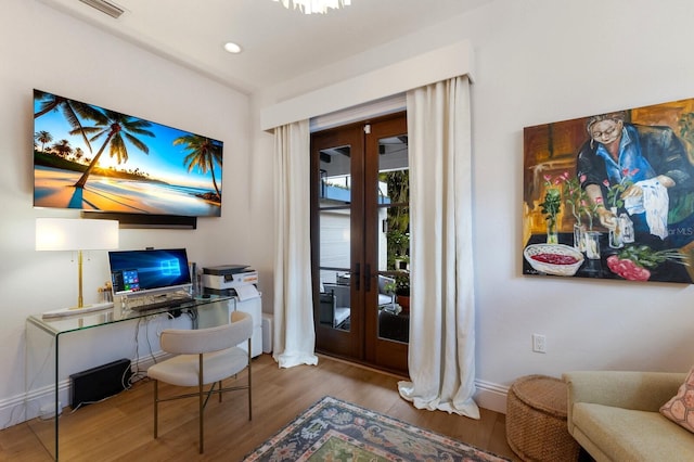 office with french doors and hardwood / wood-style floors