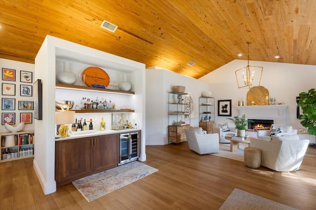 bar with lofted ceiling, wood ceiling, decorative light fixtures, wine cooler, and hardwood / wood-style flooring