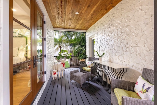 sunroom featuring wood ceiling