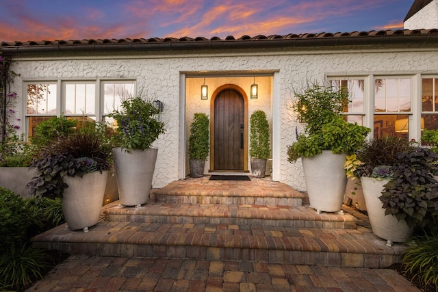 view of exterior entry at dusk