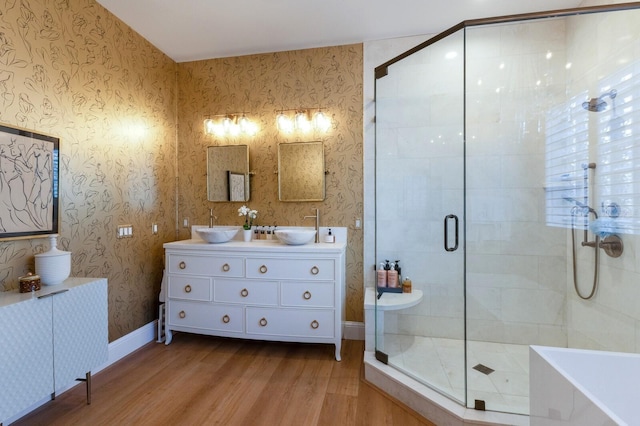 bathroom with hardwood / wood-style floors, separate shower and tub, and vanity