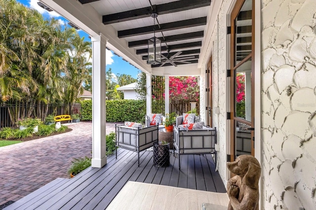 wooden terrace with ceiling fan, an outdoor hangout area, and a patio area