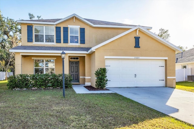 view of front of property with a front yard and a garage