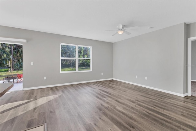 spare room with hardwood / wood-style floors and ceiling fan