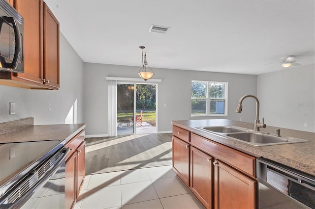 kitchen featuring ceiling fan, sink, hanging light fixtures, stainless steel appliances, and light hardwood / wood-style floors