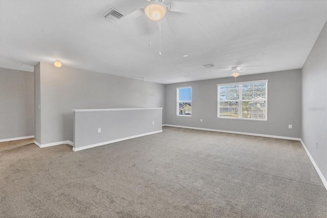 carpeted spare room featuring ceiling fan