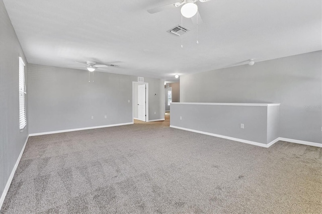 spare room with carpet flooring, ceiling fan, and plenty of natural light