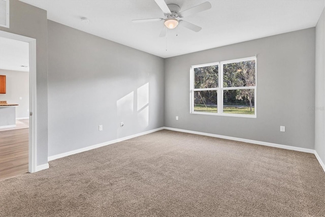 unfurnished room with carpet flooring and ceiling fan