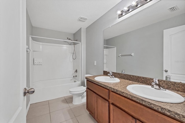 full bathroom featuring tile patterned floors, shower / bathing tub combination, a textured ceiling, toilet, and vanity