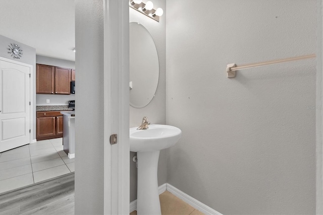 bathroom with hardwood / wood-style floors and sink