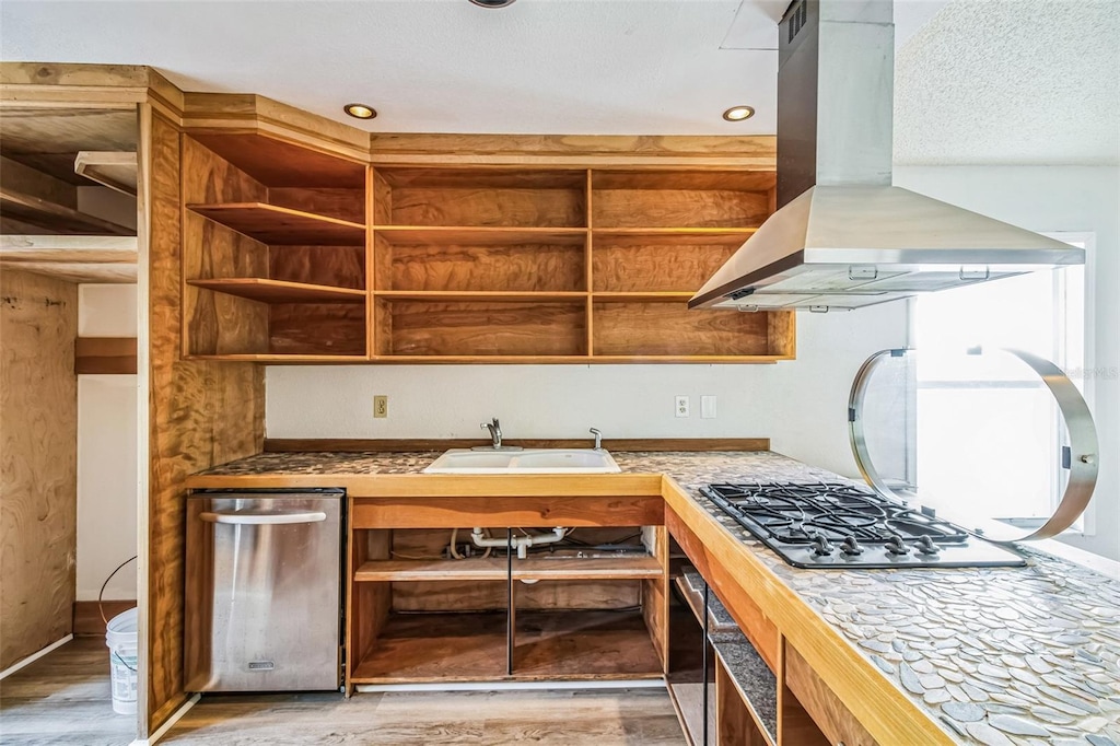 kitchen with sink, stainless steel appliances, a textured ceiling, island range hood, and light wood-type flooring