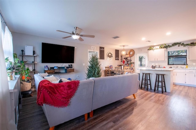 living room featuring ceiling fan and hardwood / wood-style flooring