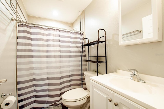 bathroom with vanity, curtained shower, and toilet