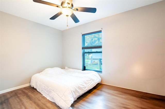 bedroom featuring ceiling fan and dark wood-type flooring