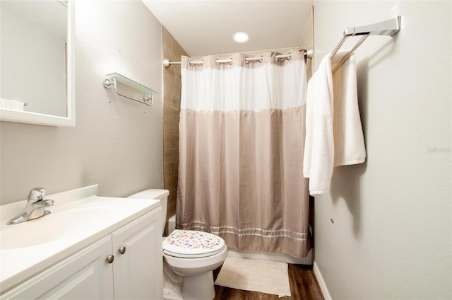 full bathroom featuring hardwood / wood-style floors, vanity, toilet, and shower / bath combo