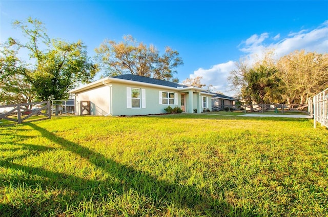 back of property featuring a yard