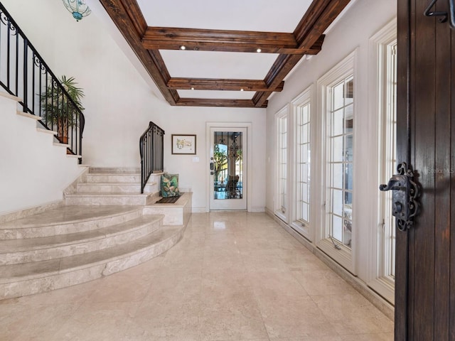 foyer entrance with beam ceiling, french doors, and coffered ceiling