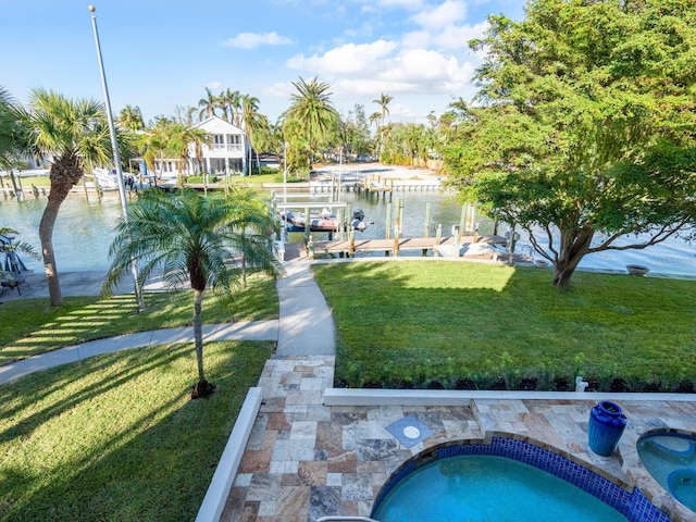 view of swimming pool with a boat dock, a water view, and a lawn