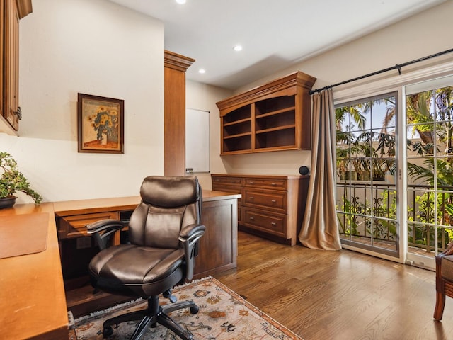 home office with dark hardwood / wood-style flooring