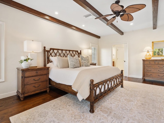 bedroom featuring beam ceiling, connected bathroom, dark hardwood / wood-style floors, and ceiling fan