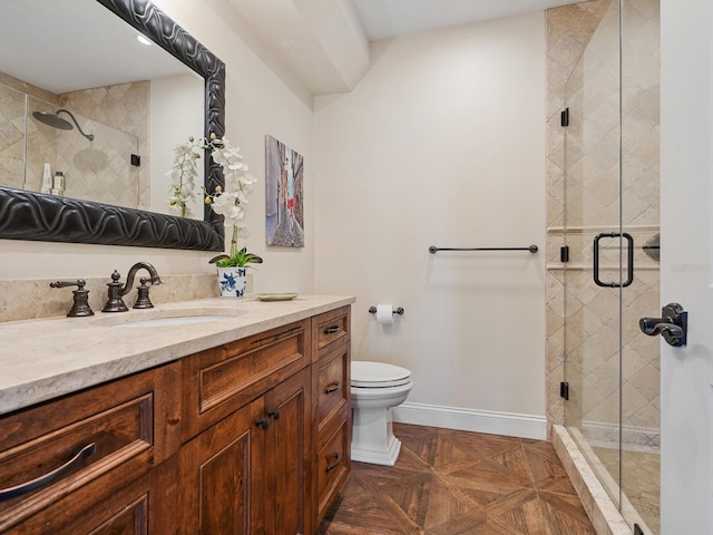 bathroom with an enclosed shower, vanity, toilet, and parquet flooring