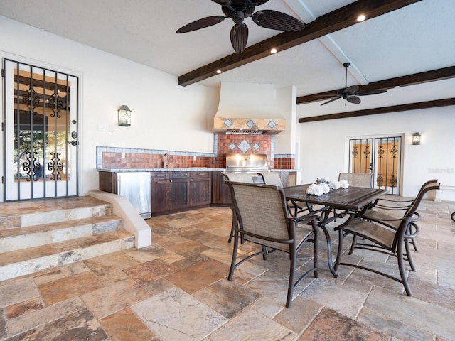 dining space with beamed ceiling and ceiling fan