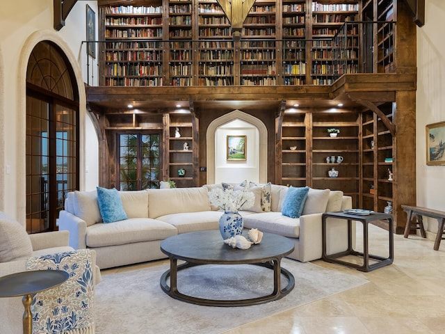 living room featuring tile patterned flooring and a high ceiling