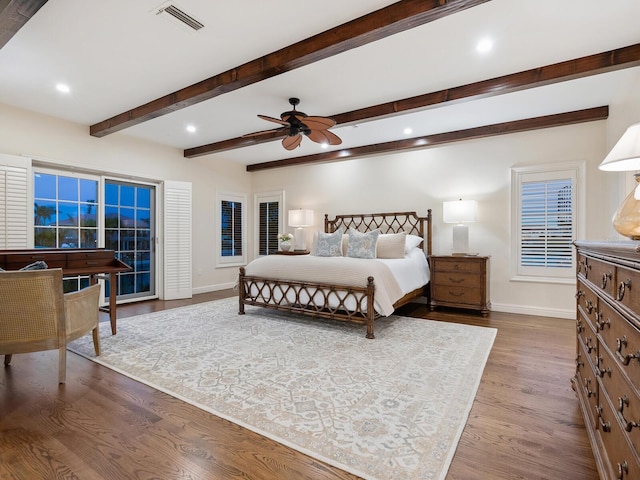 bedroom featuring hardwood / wood-style flooring, ceiling fan, and beam ceiling