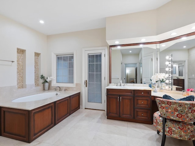 bathroom featuring a washtub, vanity, and tile patterned floors