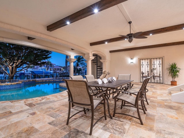 view of patio with ceiling fan and a pool with hot tub