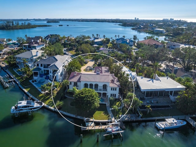 birds eye view of property with a water view