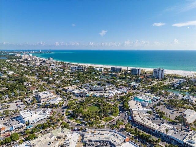 birds eye view of property with a beach view and a water view