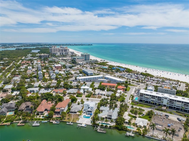 drone / aerial view featuring a water view and a beach view