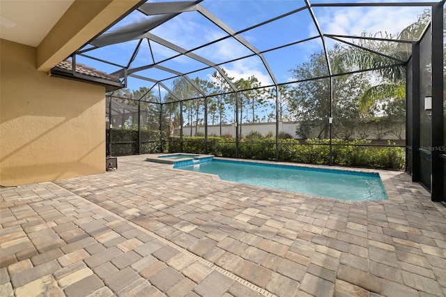 view of swimming pool featuring a lanai, a patio area, and an in ground hot tub