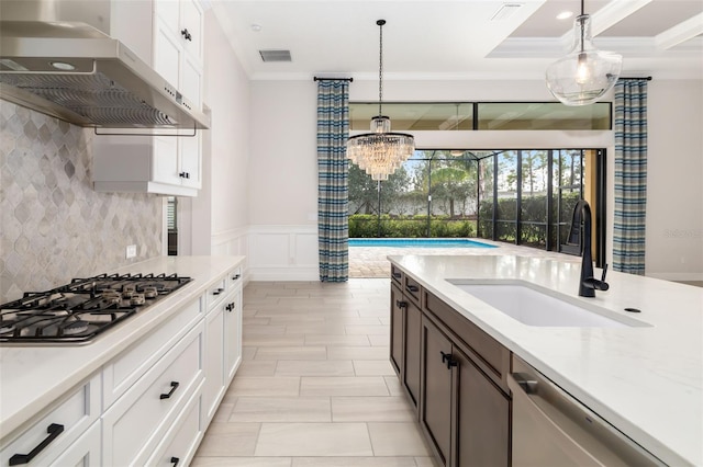 kitchen featuring sink, stainless steel appliances, pendant lighting, extractor fan, and white cabinets