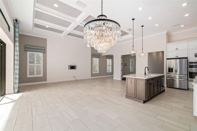 kitchen featuring white cabinetry, coffered ceiling, stainless steel refrigerator with ice dispenser, pendant lighting, and a kitchen island with sink