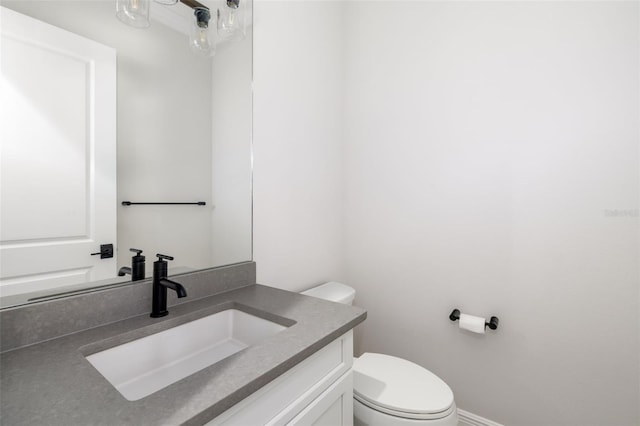 bathroom featuring vanity and toilet