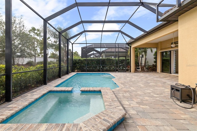 view of pool featuring a patio area, ceiling fan, and a lanai