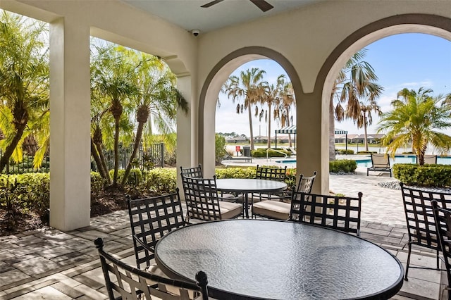 view of patio / terrace with ceiling fan and a community pool