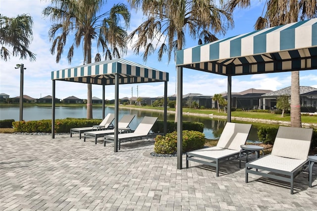 view of patio with a gazebo and a water view