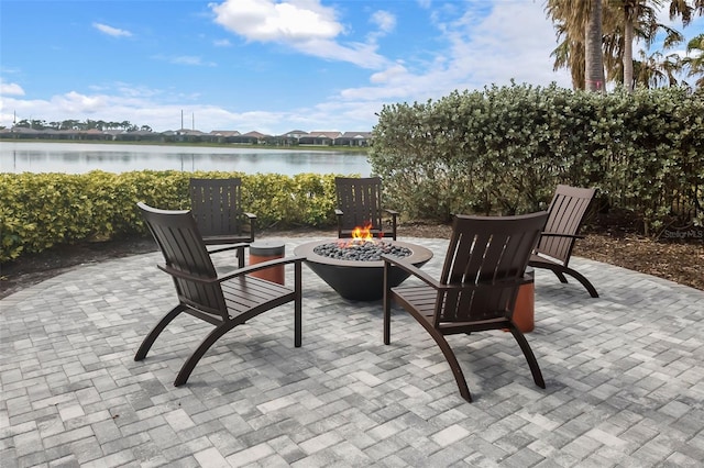 view of patio / terrace with a water view and a fire pit