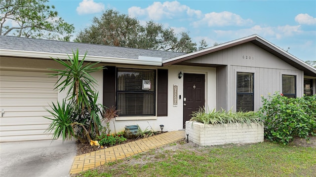 view of front of house with a front yard and a garage