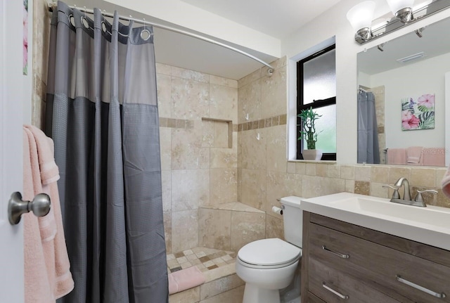 bathroom featuring vanity, tasteful backsplash, tile walls, toilet, and walk in shower