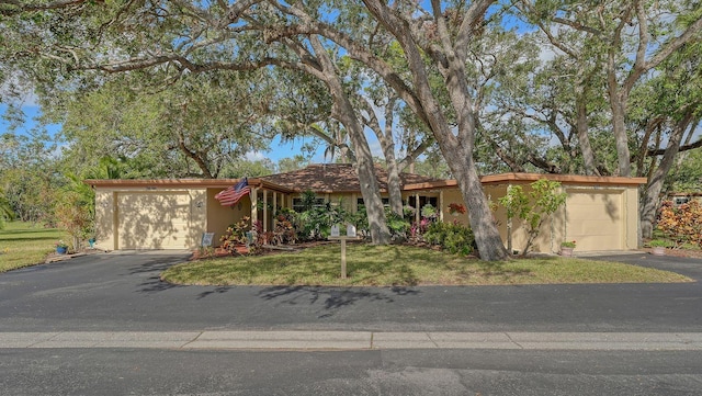 ranch-style house with a front yard and a garage