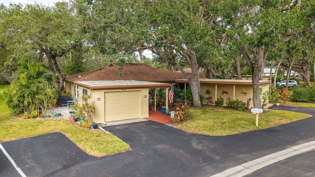 single story home with a front yard and a garage